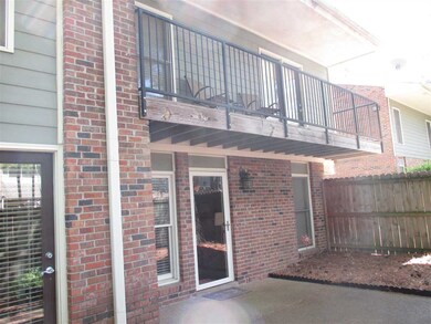 Large, wood privacy fenced patio with upstairs bal