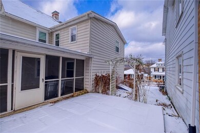 LARGE SCREENED IN PORCH WITH A WALK OUT TO A PATIO