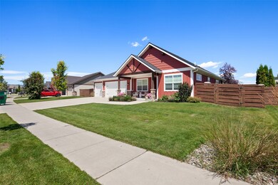 View of front of home featuring concrete driveway and yard