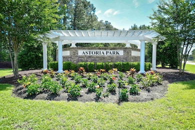 Community / neighborhood sign featuring a yard