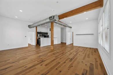 Unfurnished living room featuring wood-type floori