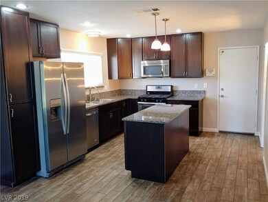 Kitchen has an island and plenty of storage space.