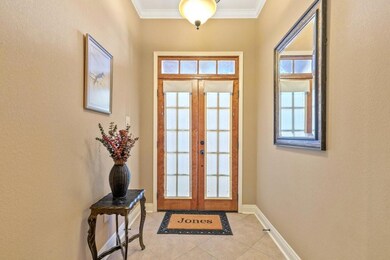 Foyer Entrance: Double wooden door entrance.