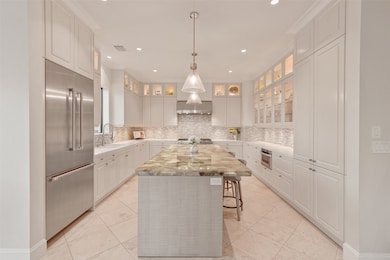 The kitchen features a 48 inch gas range with commercial grade vent hood, built-in refrigerator and freezer, nugget ice maker, wine fridge and much more.