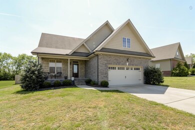 Beautiful brick and stone exterior with covered front porch to welcome you home