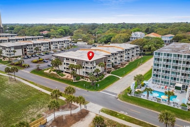 Drone / aerial view of a pool and apartment complex / building