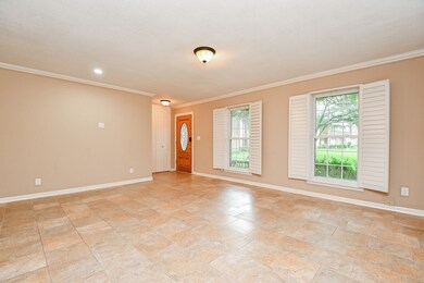 Bright living area with tiled floors, neutral wall