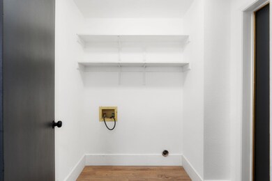 Laundry room featuring washer hookup, baseboards,