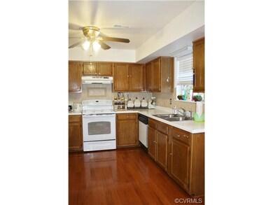 Kitchen has beautiful tiled backsplash and a windo
