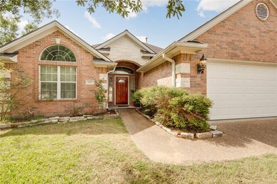 View of front facade with brick siding, a front la