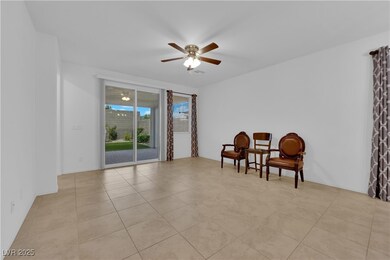 Sitting room with visible vents, a ceiling fan, an