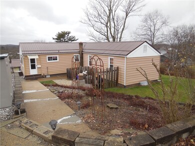 View of back of home and landscaping.