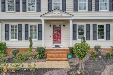 The red craftsman style door and stained wood pane