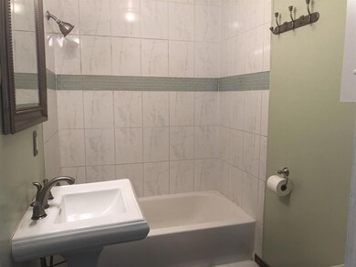The bathroom has been redone and has a pedestal sink, and lovely tile work.