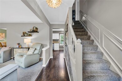 Stairway featuring dark hardwood floors and ornamental molding