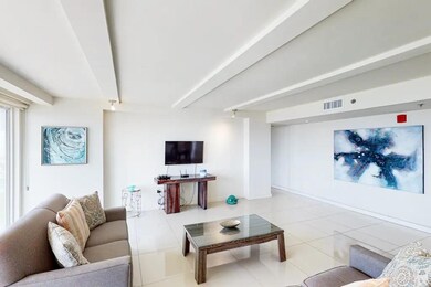 Tiled living room featuring beamed ceiling