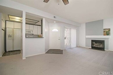 View from dining room to kitchen, front door and f