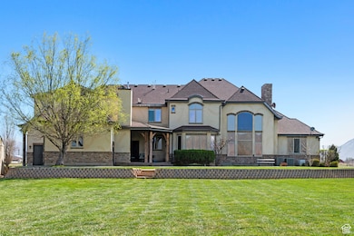 View of front of property featuring a front yard, stucco siding, and a chimney
