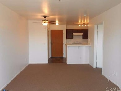View of entry door, front living room and kitchen