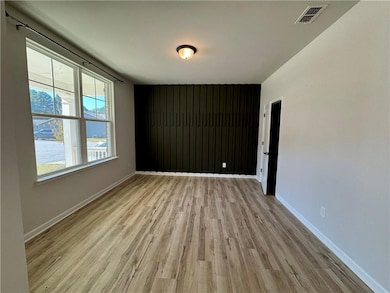 Empty room with light wood-type flooring and a water view