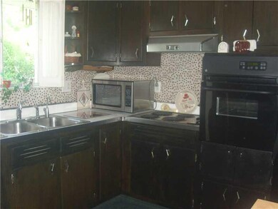 Kitchen. Kitchen has a ceramic tile backsplash.