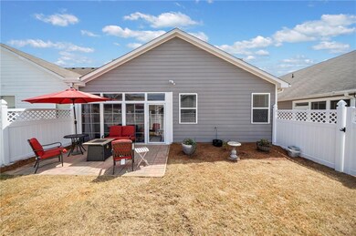 Back of house featuring a fenced backyard, a lawn,