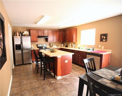 Open kitchen with island and large pantry.