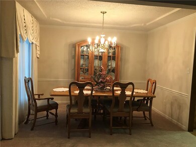Spacious dining area - custom drapes.