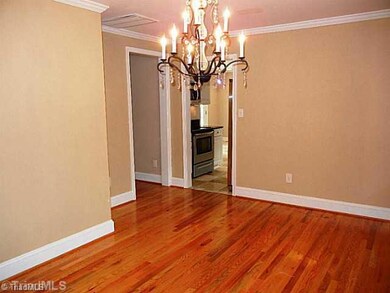 Dining Room. Formal dining rm with beautiful hardwoods, crown molding, large picture window, and beautiful chandelier