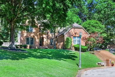 View of front of property featuring brick siding and a front lawn