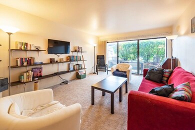Living room with shelving along wall.