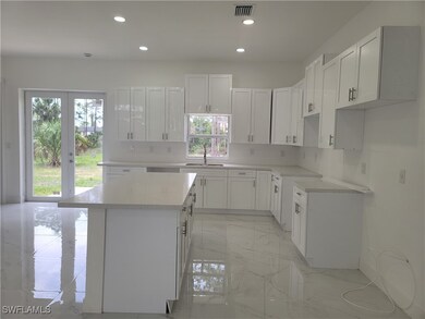 Kitchen with light marble finish flooring, a kitch