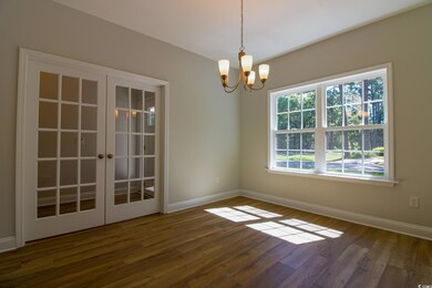 Unfurnished room featuring baseboards, dark wood-s