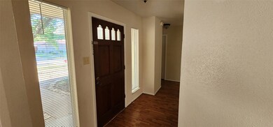 Inviting entryway with a wooden front door featuri