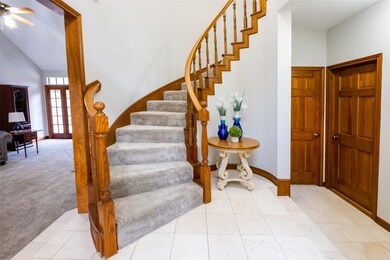 This grand staircase welcomes you as you open the front door.  To the left is the living room.   Kitchen to the right.  Other door opens into a half bath.