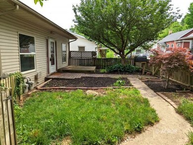 Fenced front yard w/perennial flower bed