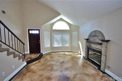 Living room with arched window and fireplace