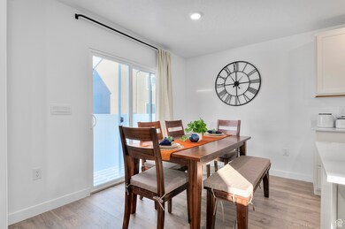 Dining area featuring light wood-type flooring and baseboards