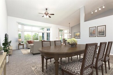 The generous living room w/ bay window and dining 
