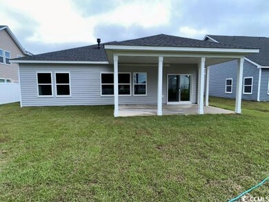 Rear view of house featuring a patio area and a ya