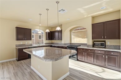 Kitchen featuring black electric range oven, stain