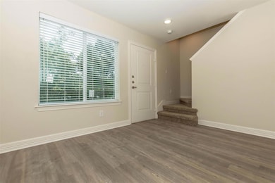 Foyer entrance with baseboards, wood finished flo