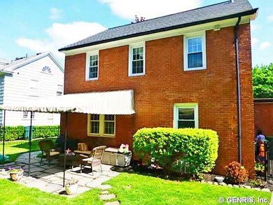 Exterior Back. Backyard stone patio with awning co