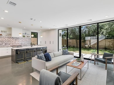 Living area featuring recessed lighting, a wall o