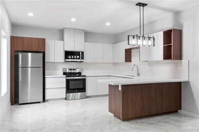 Kitchen with sink, hanging light fixtures, white cabinets, stainless steel appliances, and backsplash