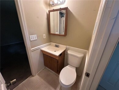 Half bathroom featuring vanity and tile patterned flooring