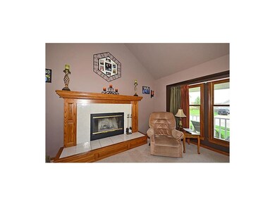 Great Room has fireplace with ceramic tile and rai