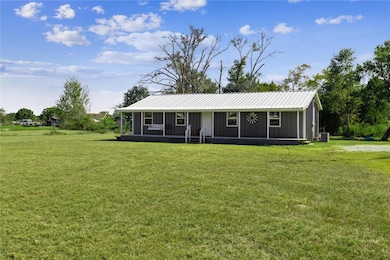 View of front facade featuring a front yard, a sun