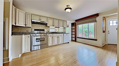 Renovated kitchen with granite counter tops and tile backsplash
