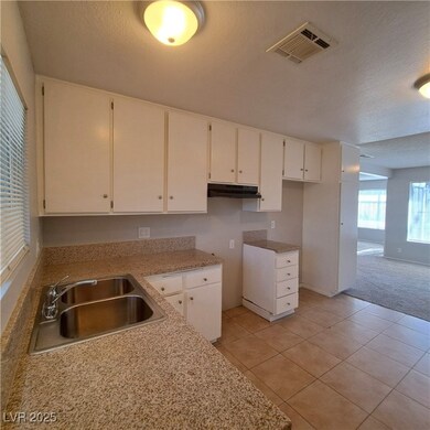 Kitchen featuring a textured ceiling, visible vent
